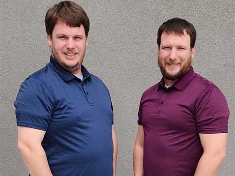 Two brothers posing for a photo together